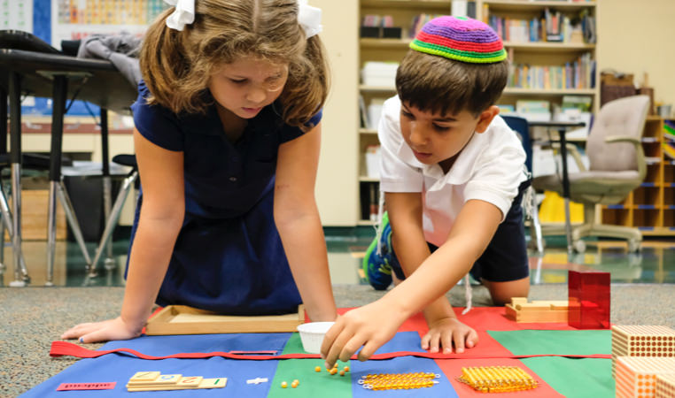 a young boy and young girl in classroom